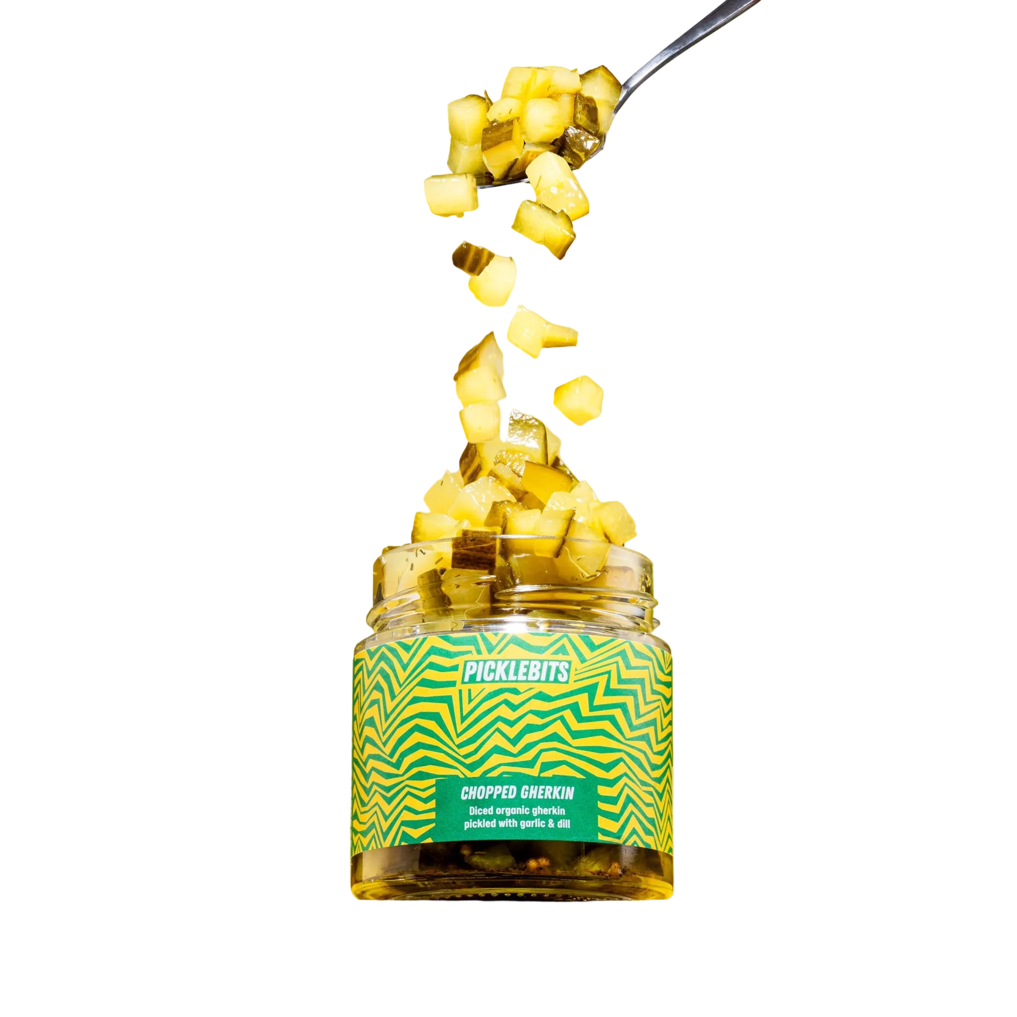 Jar of Picklebits chopped pickles with a spoonful being poured over, on a white background