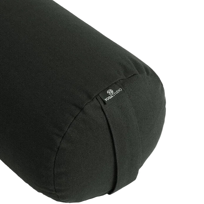 Black yoga bolster with a brand label on a white background