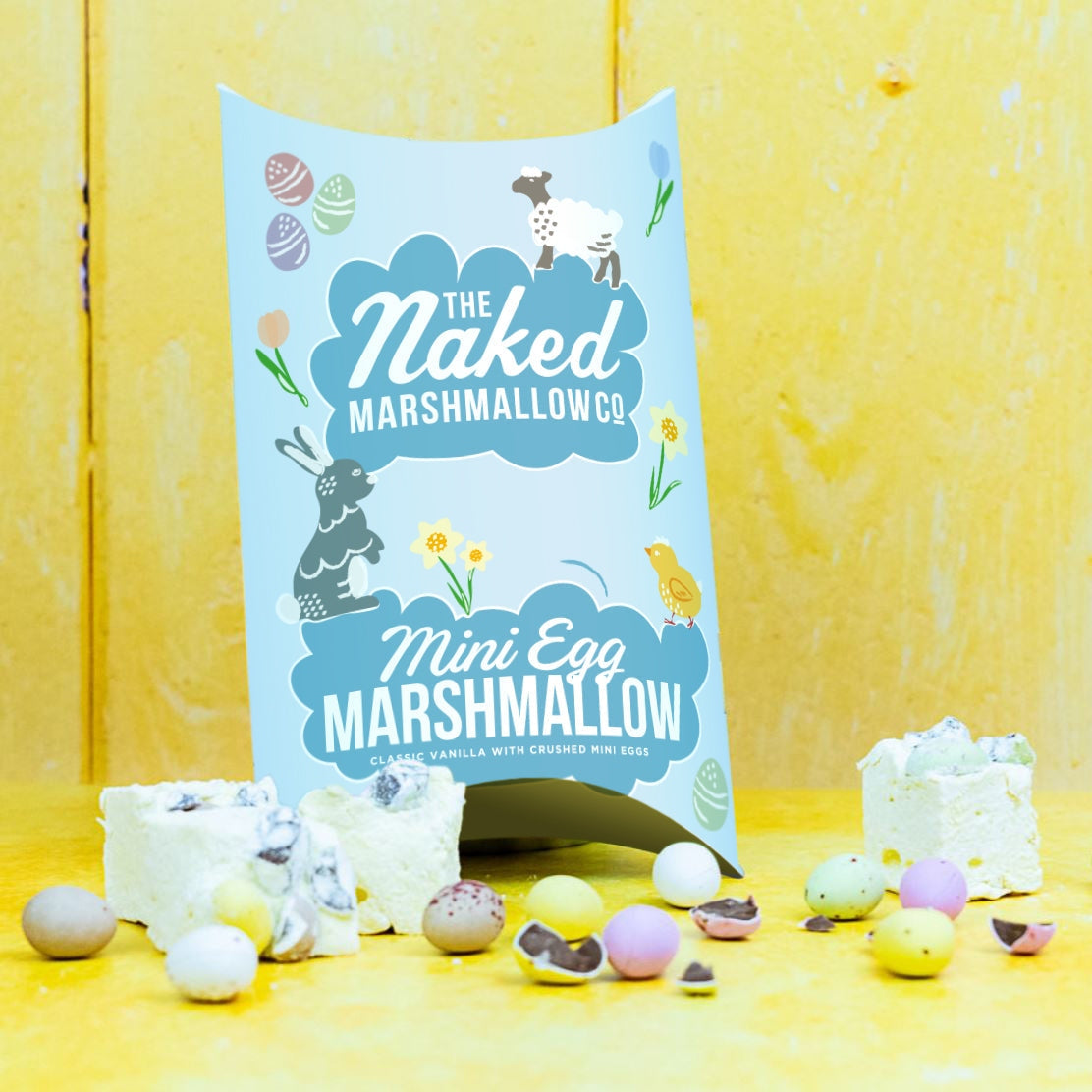 Naked Marshmallow Co. Mini Egg Marshmallow packaging with marshmallows on a yellow background