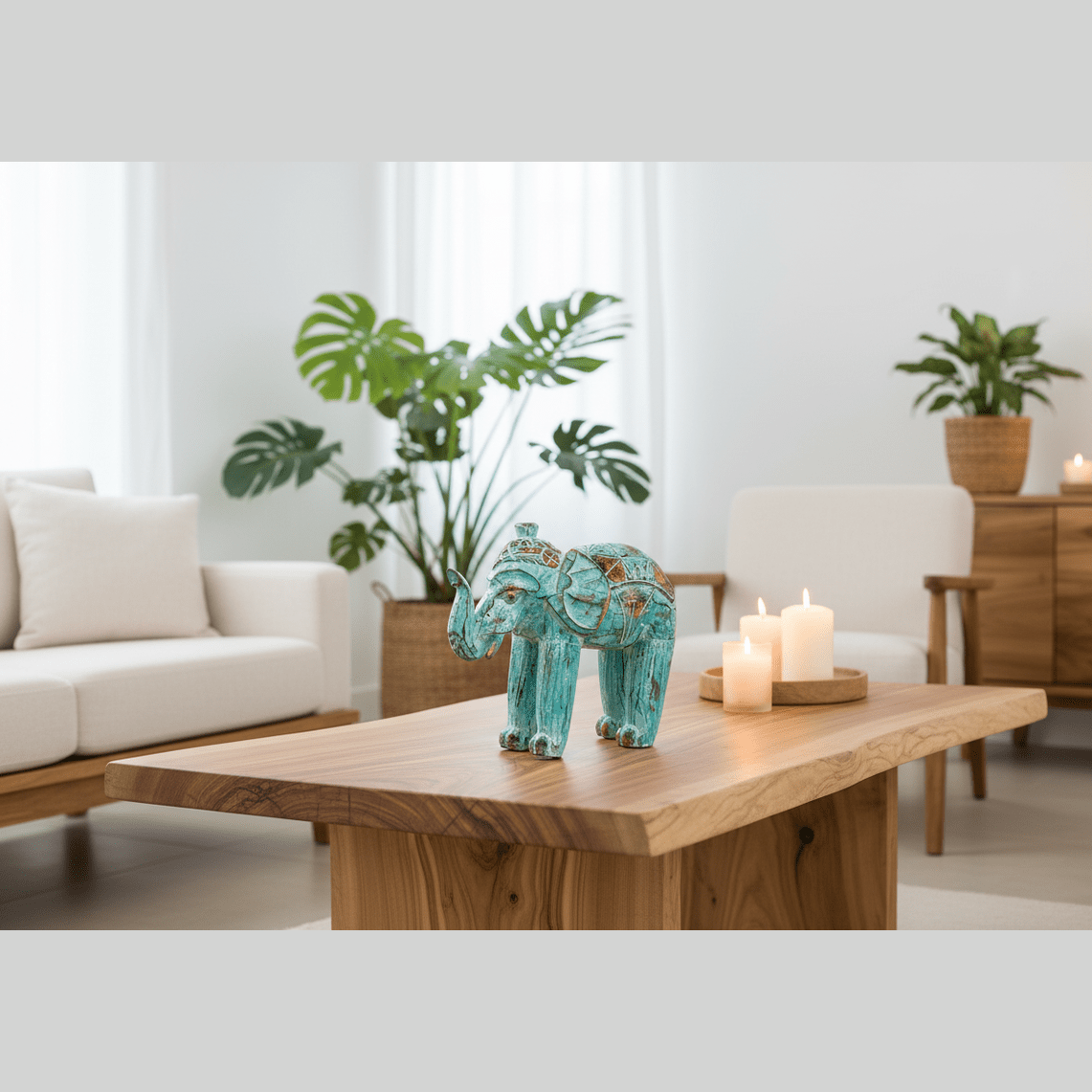 Decorative elephant on a wooden table in a living room with plants and candles.