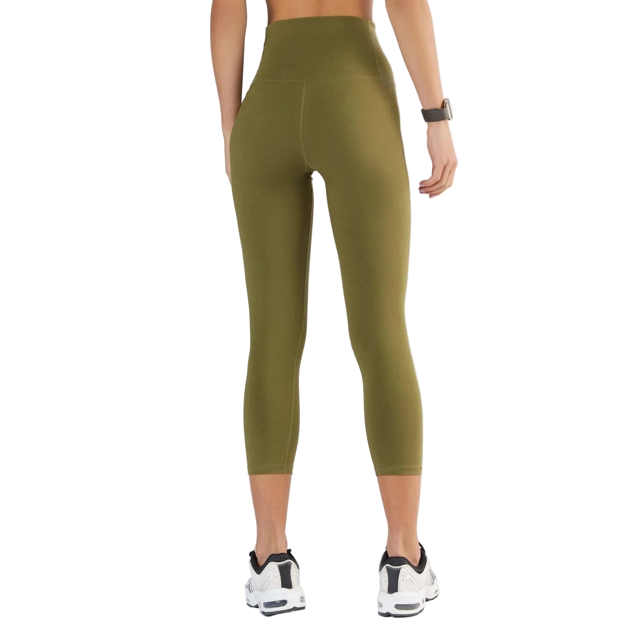 Person wearing olive green leggings on a white background