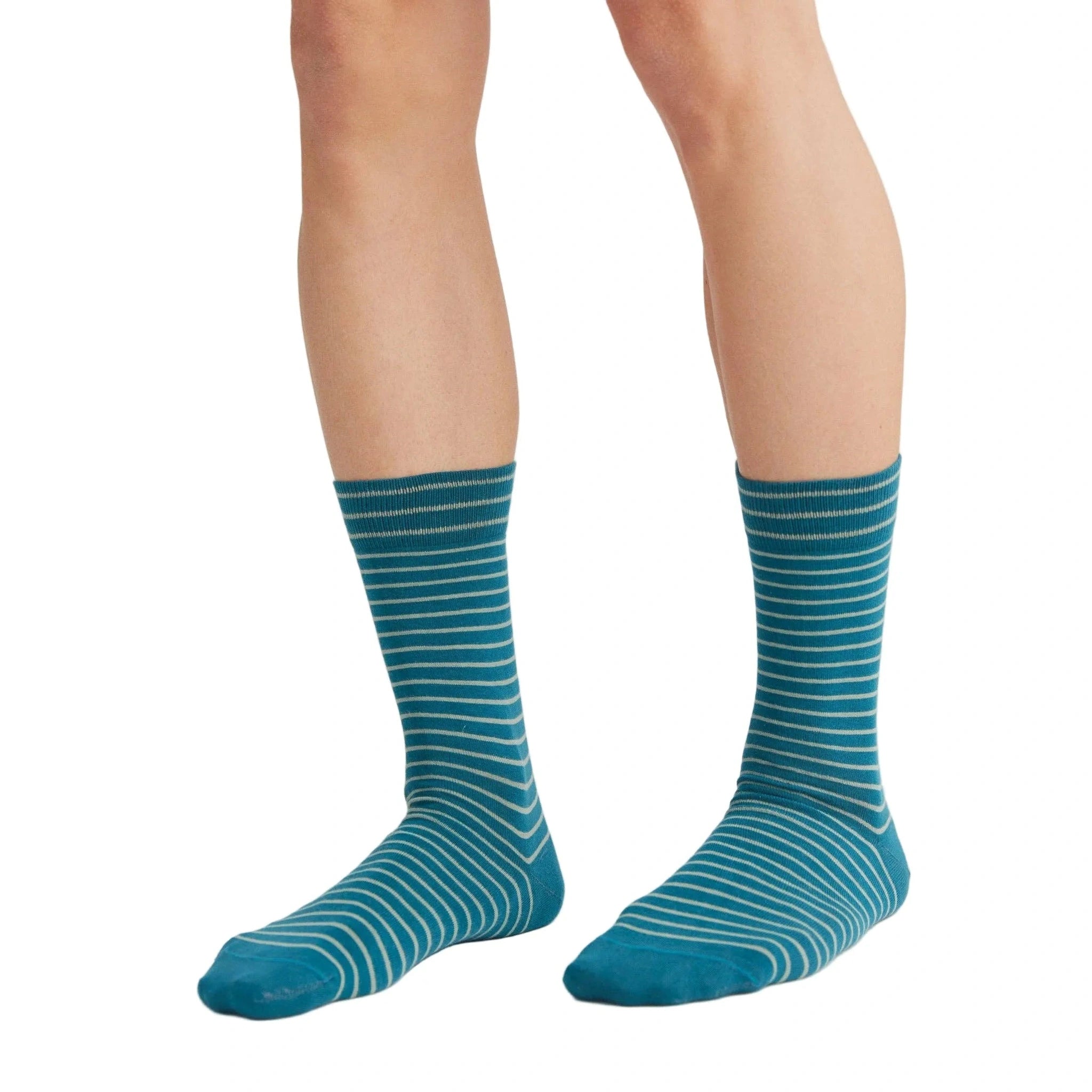 Teal striped socks worn by a person on a white background