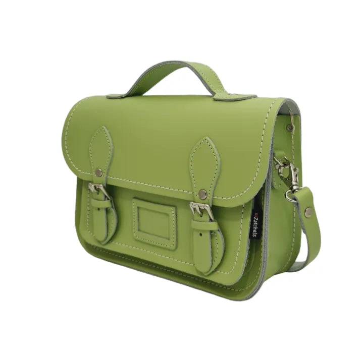 Angled view of Zatchels Grass Green midi satchel showing the front pocket and detachable shoulder strap