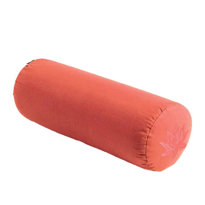 Orange cylindrical yoga bolster with a leaf design on a light gray background