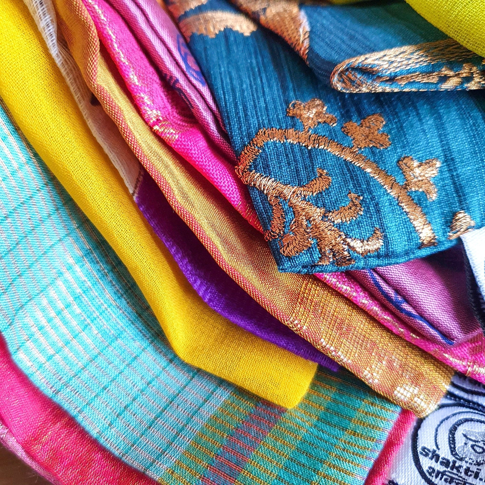 Stack of colorful fabric swatches with embroidery