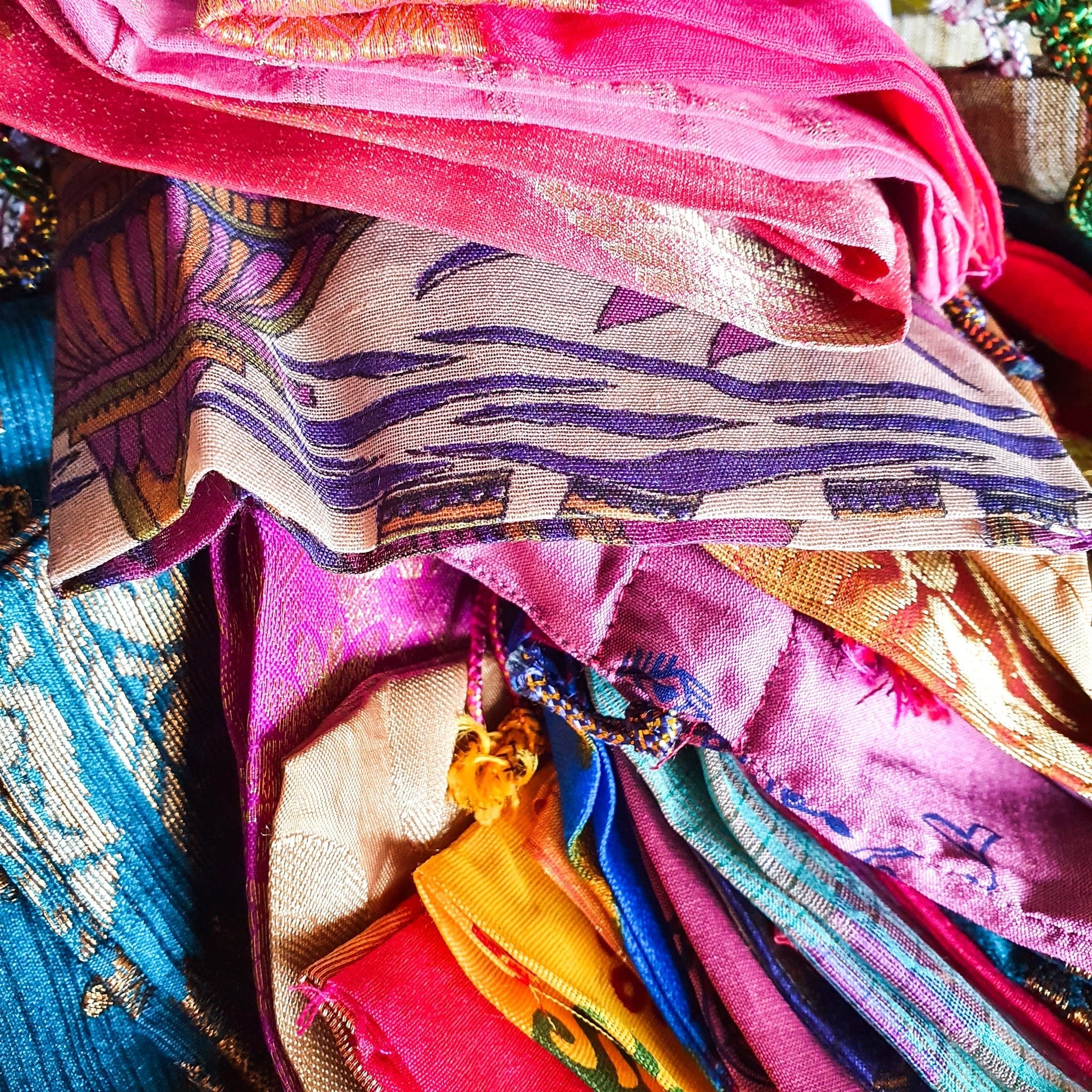 Stack of colorful fabric with various patterns and colors.