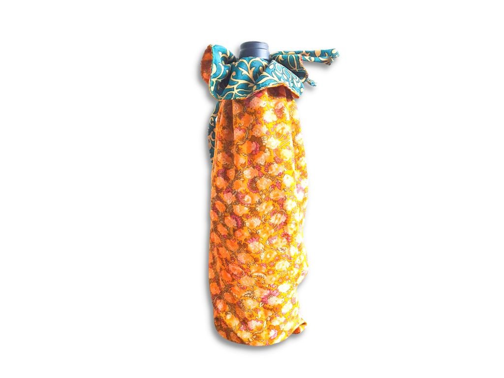 Decorative bottle with a floral wrap on a white background