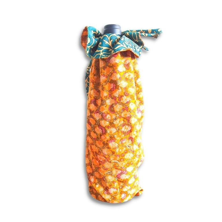 Decorative bottle with a floral wrap on a white background