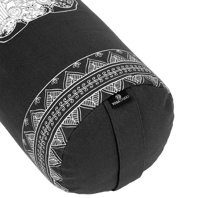 Black yoga bolster with white patterns on a white background