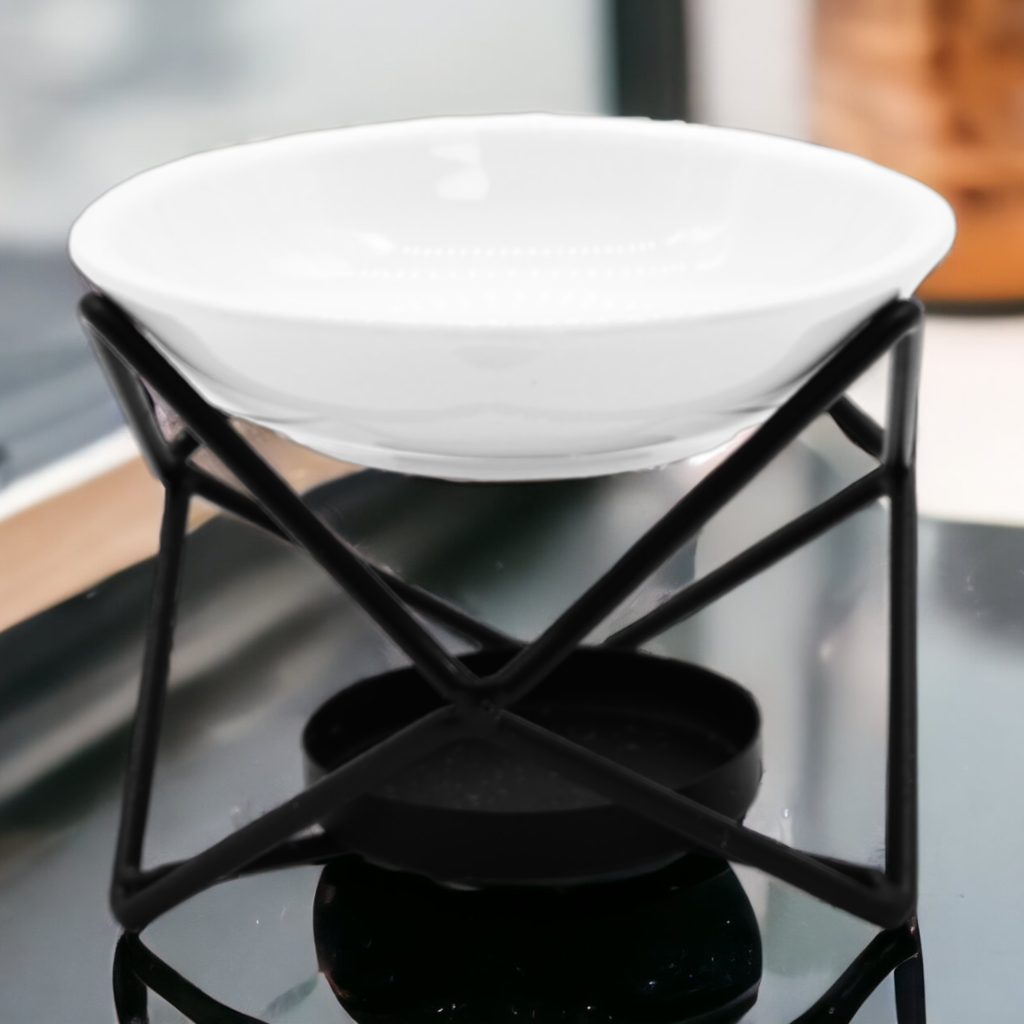 Wax Melt Burner - Ceramic & Metal Oil Burner - Black & White - 4 Designs. Designed with precision, this simple stand blends form and function seamlessly. It's the perfect choice for diffusing fragrance oils, simmering granules, or enjoying Wax Melts, transforming any room into a tranquil retreat.
