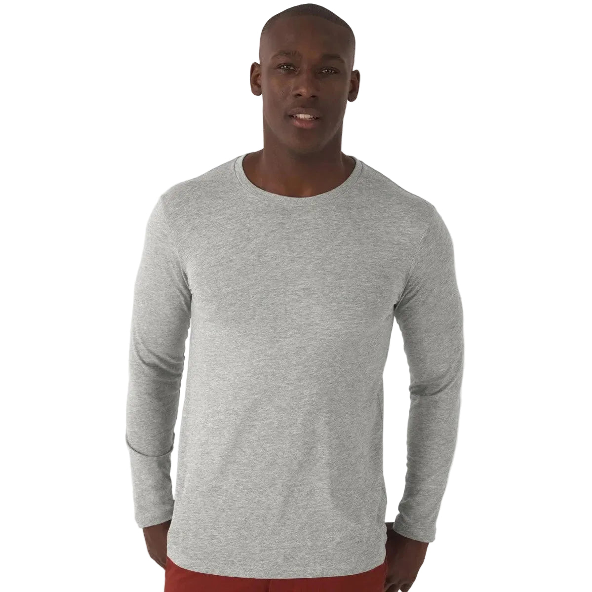 Man wearing a grey long-sleeve shirt against a white background