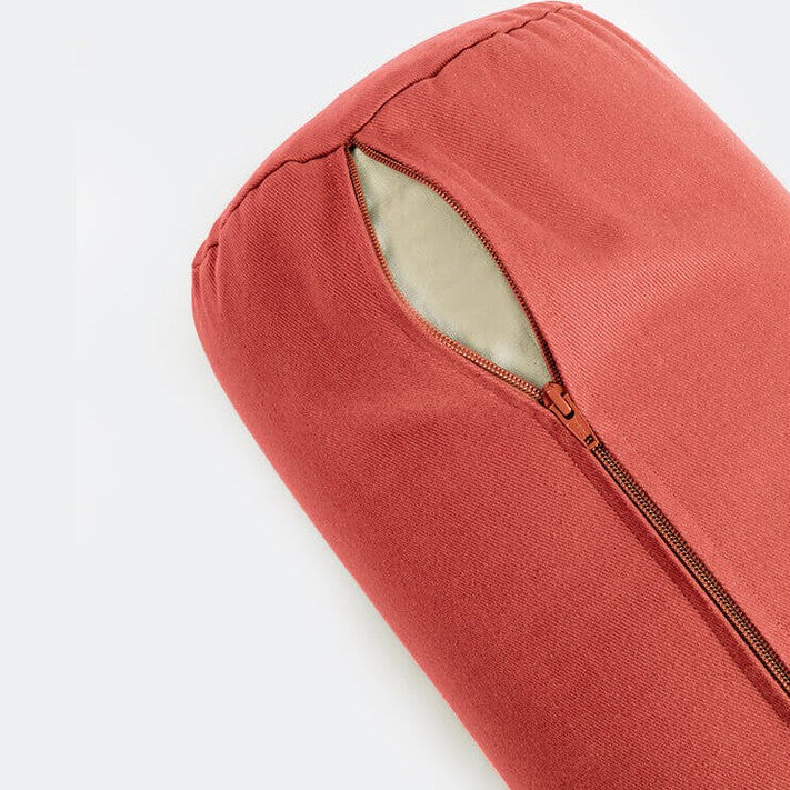 Red cushion with a zipper on a light gray background