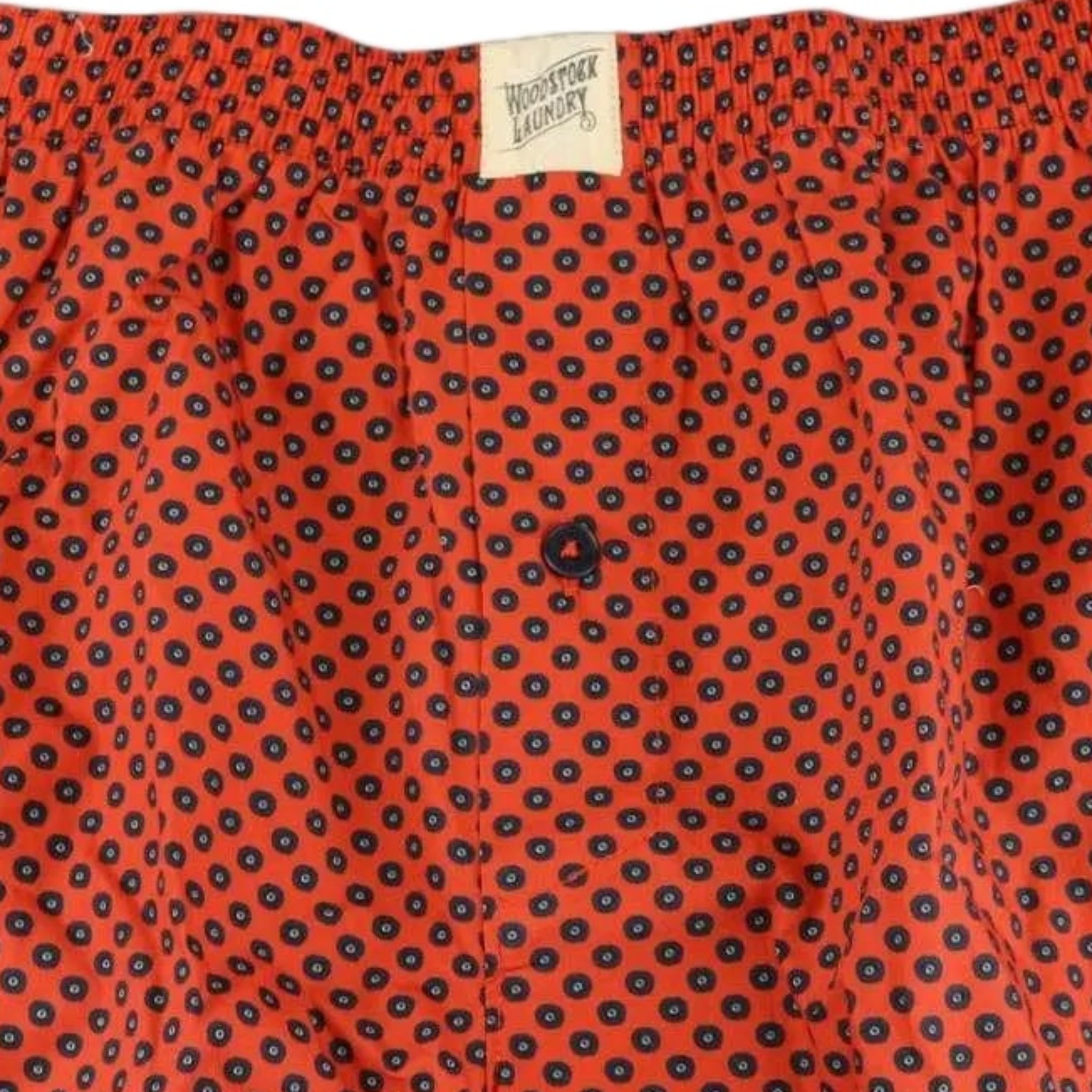 Red boxer shorts with a navy blue pattern and 'Woodstock Laundry' label on the waistband.