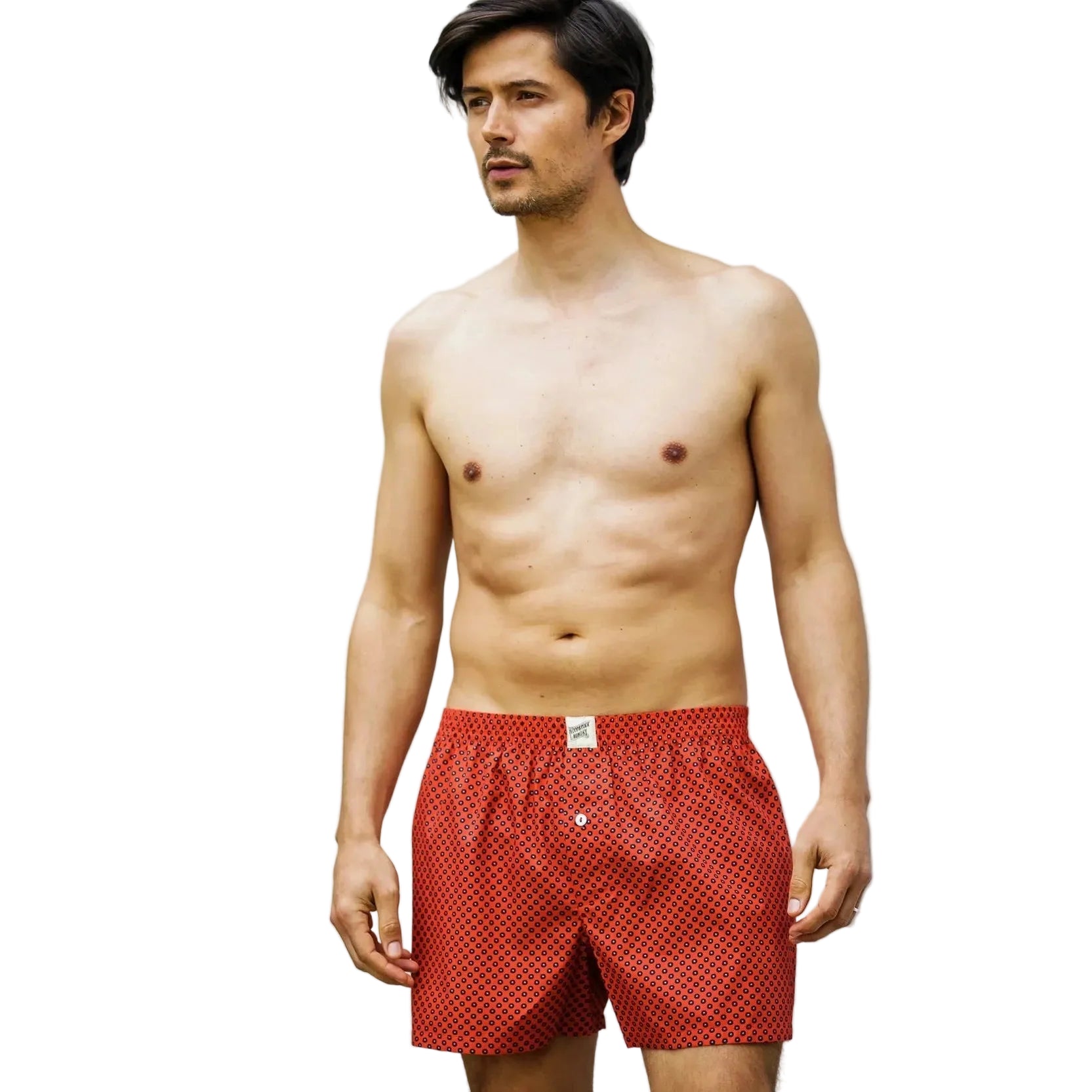 Man wearing red patterned boxer shorts on a white background