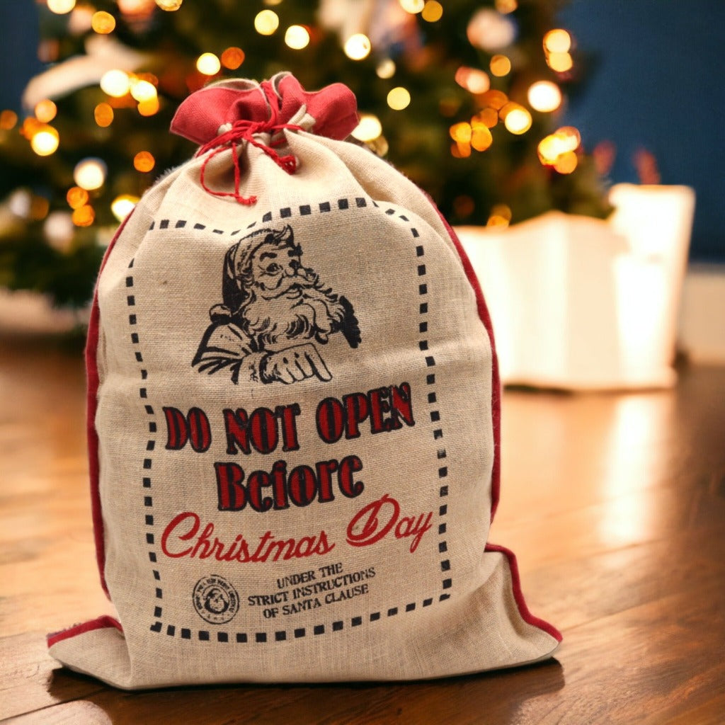 Reusable Christmas Present Bags - Santa Sacks - Natural Xmas Stockings. This wonderfully festive Jute Sack is strong and sturdy. Fill it with presents for your friends and family and also reuse it next year so you can get plenty of use out of it. Made in India. Available in four different designs. Colour Natural Black and Red. Size of the Jute Santa Bag: 76cm x 55cm Size: H: 76 cm; W: 55 cm. Material Jute