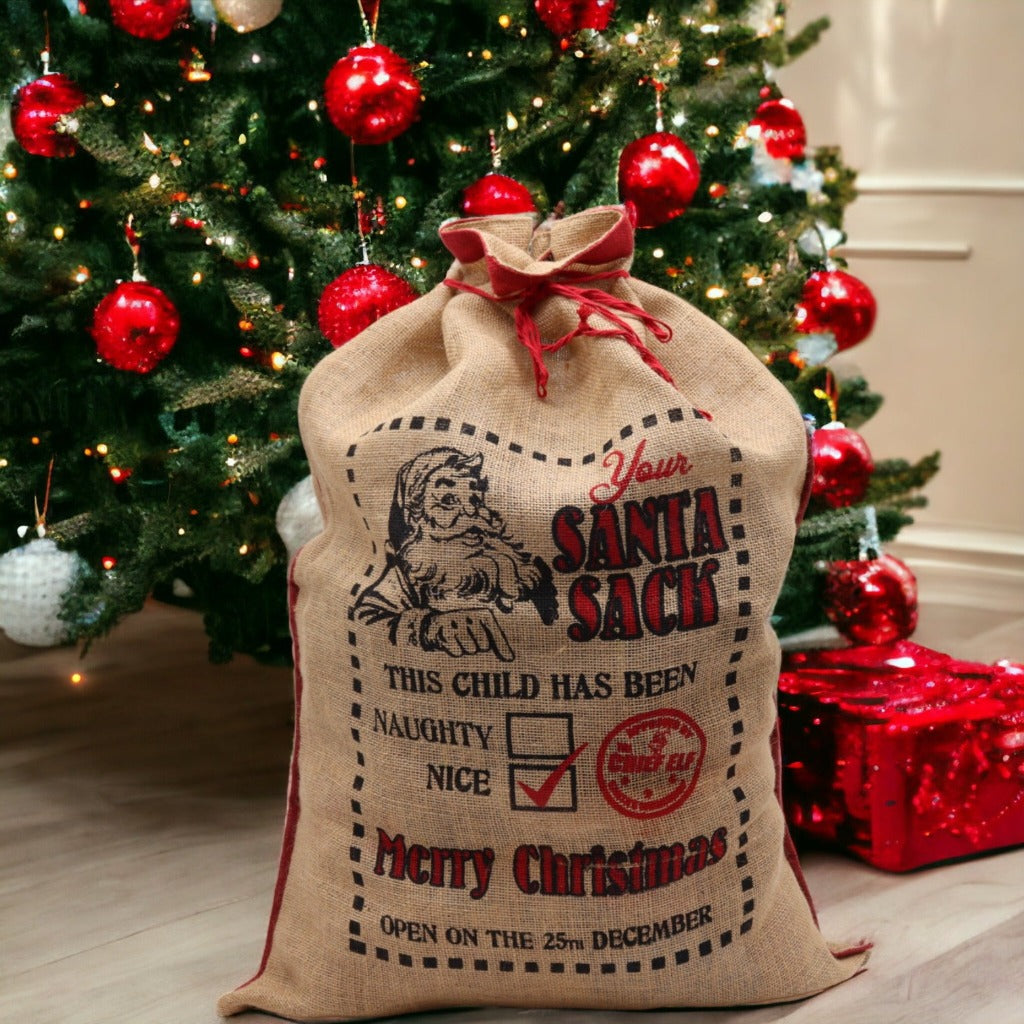 Reusable Christmas Present Bags - Santa Sacks - Natural Xmas Stockings. This wonderfully festive Jute Sack is strong and sturdy. Fill it with presents for your friends and family and also reuse it next year so you can get plenty of use out of it. Made in India. Available in four different designs. Colour Natural Black and Red. Size of the Jute Santa Bag: 76cm x 55cm Size: H: 76 cm; W: 55 cm.  Material Jute