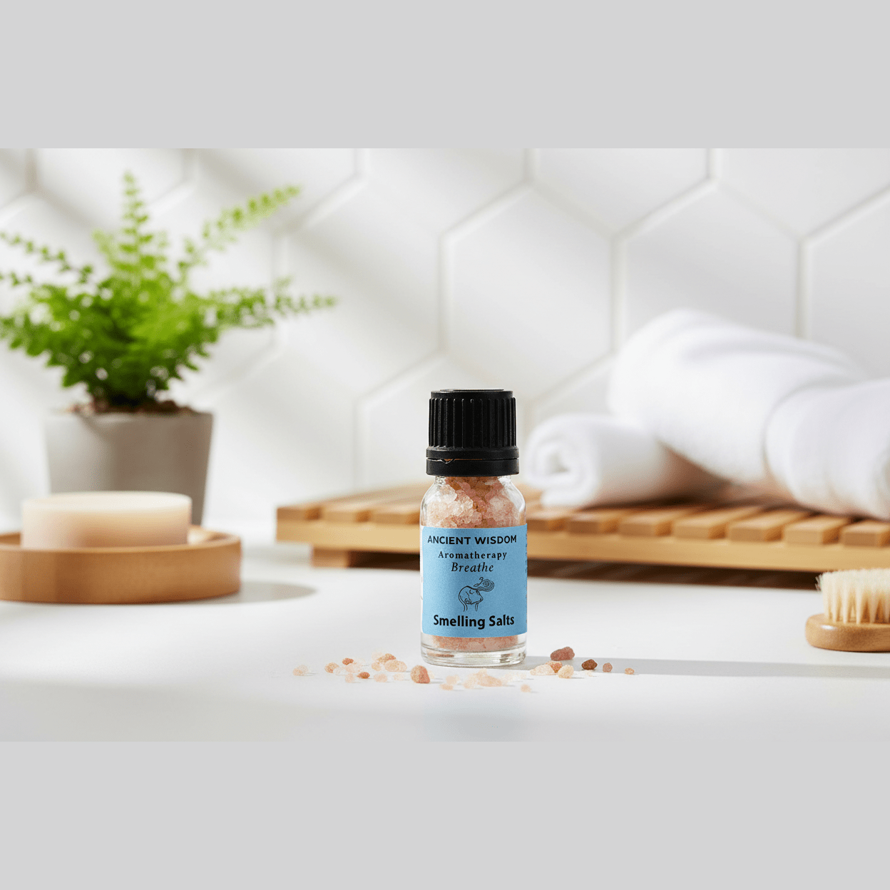 A bottle of aromatherapy smelling salts on a wooden surface in a bathroom setting