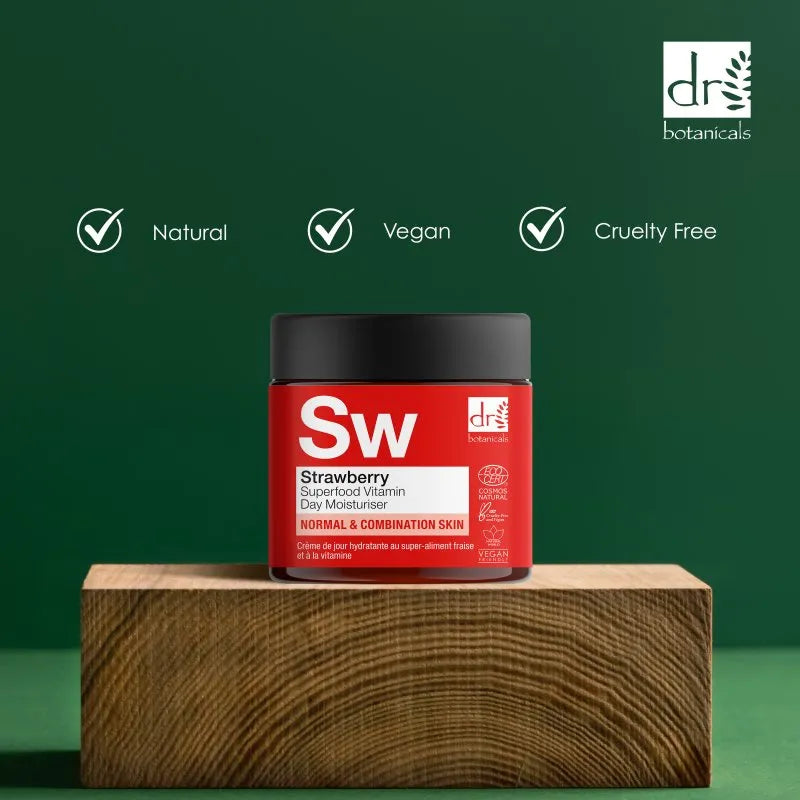 Red jar with black lid on a wooden block against a green background, featuring 'Dr Botanicals' branding.