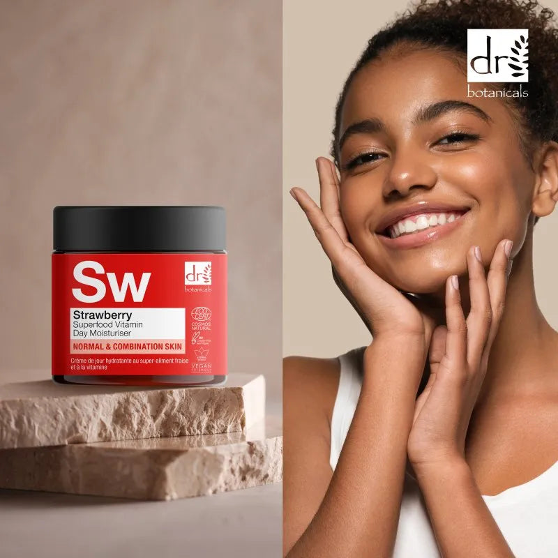 Dr Botanicals strawberry day moisturiser jar with a woman touching her face on a beige background