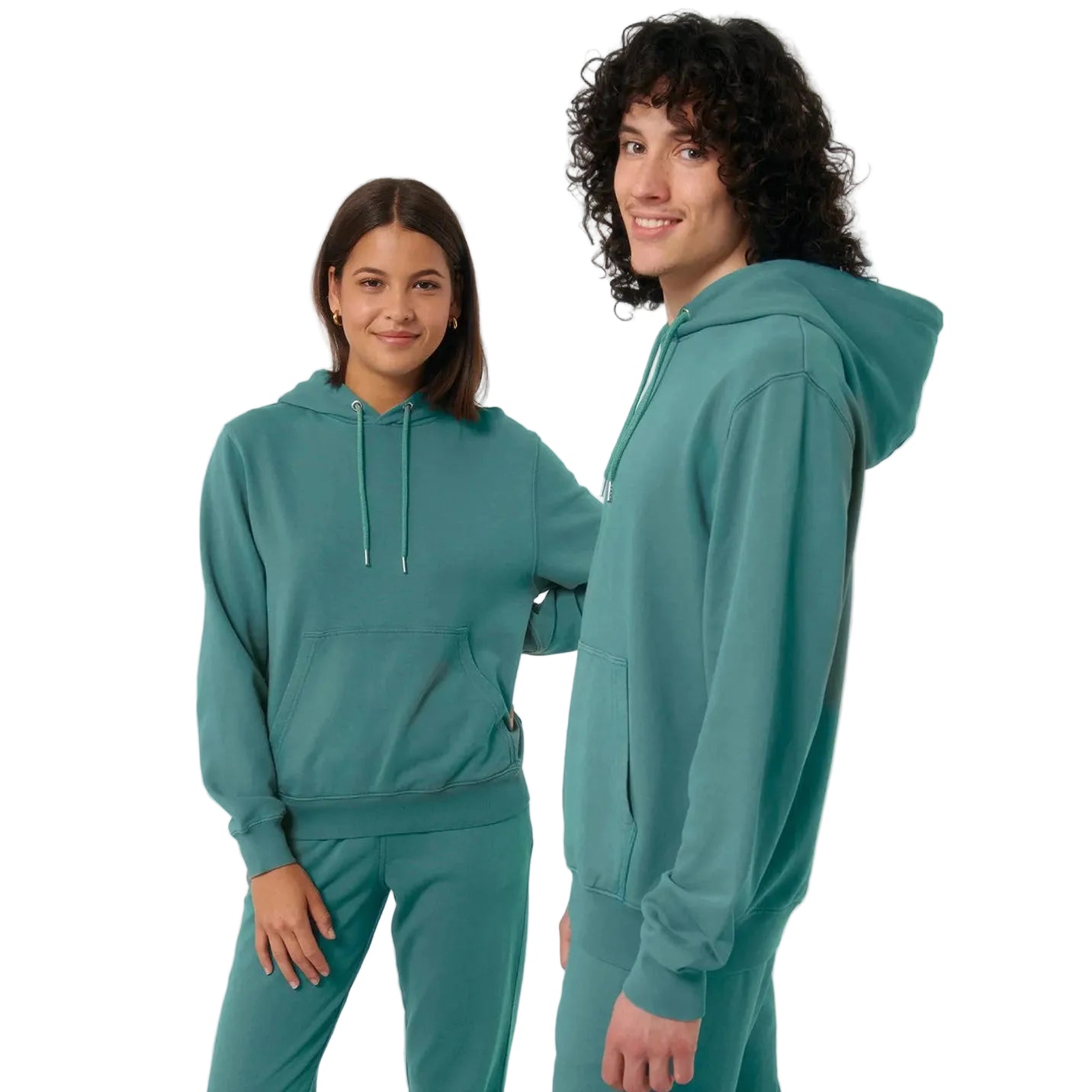 Two people wearing matching teal hoodies and pants on a plain background