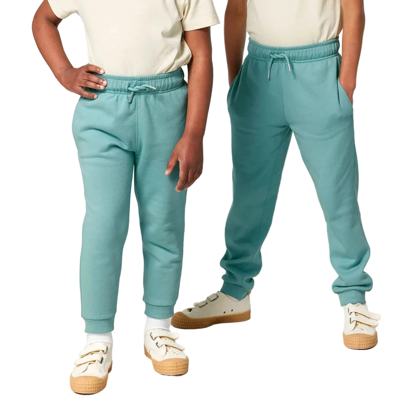 Two people wearing matching teal jogger pants on a white background