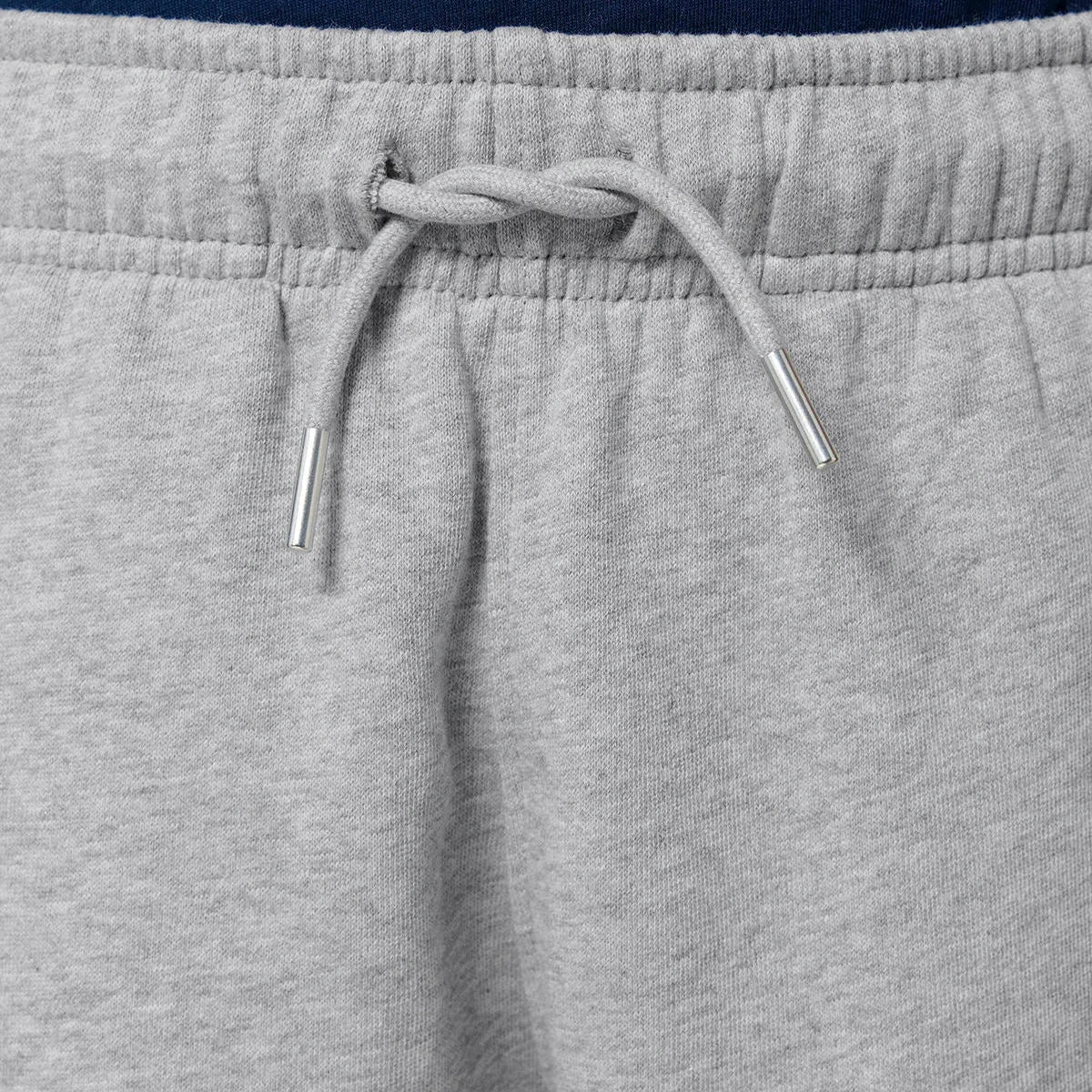 Close-up of grey sweatpants with a drawstring
