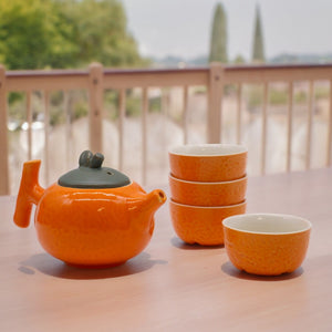 Emmy Jane - Herbal Teapot Set - Orange Teapot & Four Cups. This charming set features a teapot shaped like a plump orange and four matching cups with a textured orange peel design.  The vibrant design and compact size make it the perfect gift.