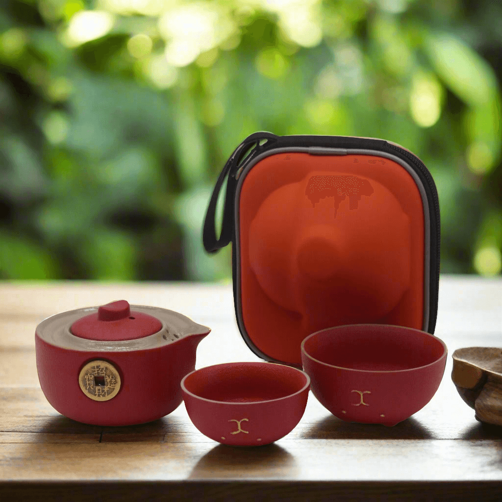 Emmy Jane -T ravel Teapot Set for 2 - Money Cat Teapot Set - Black or Red. Add a touch of charm and elegance to your travels. This delightful Money Cat Teapot Set features a uniquely designed teapot and two matching cups, all neatly packed in a stylish travel case, perfect for tea lovers on the go. The teapot features a sleek black finish adorned with a golden money design, symbolizing prosperity and good fortune.