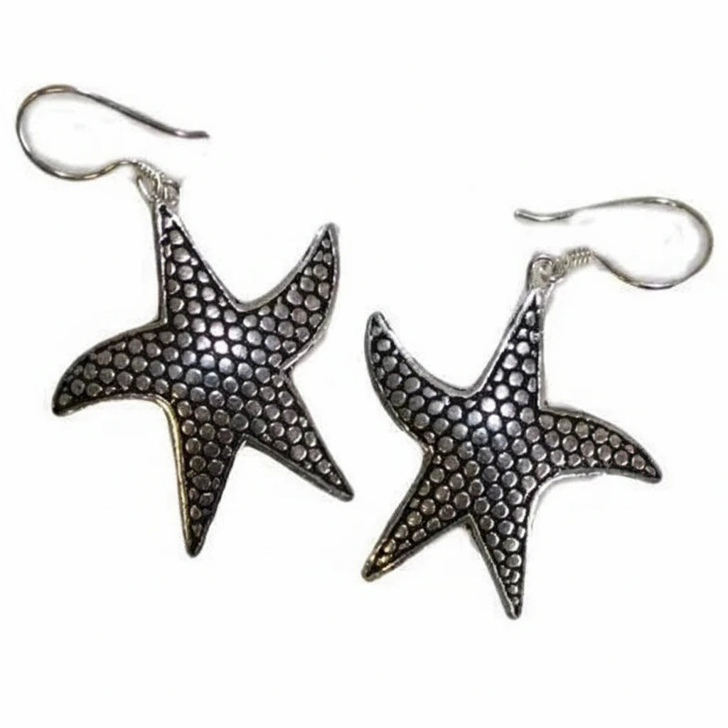 A pair of silver starfish drop earrings with a textured, hammered surface and silver fishhook wires, shown on a plain white background.