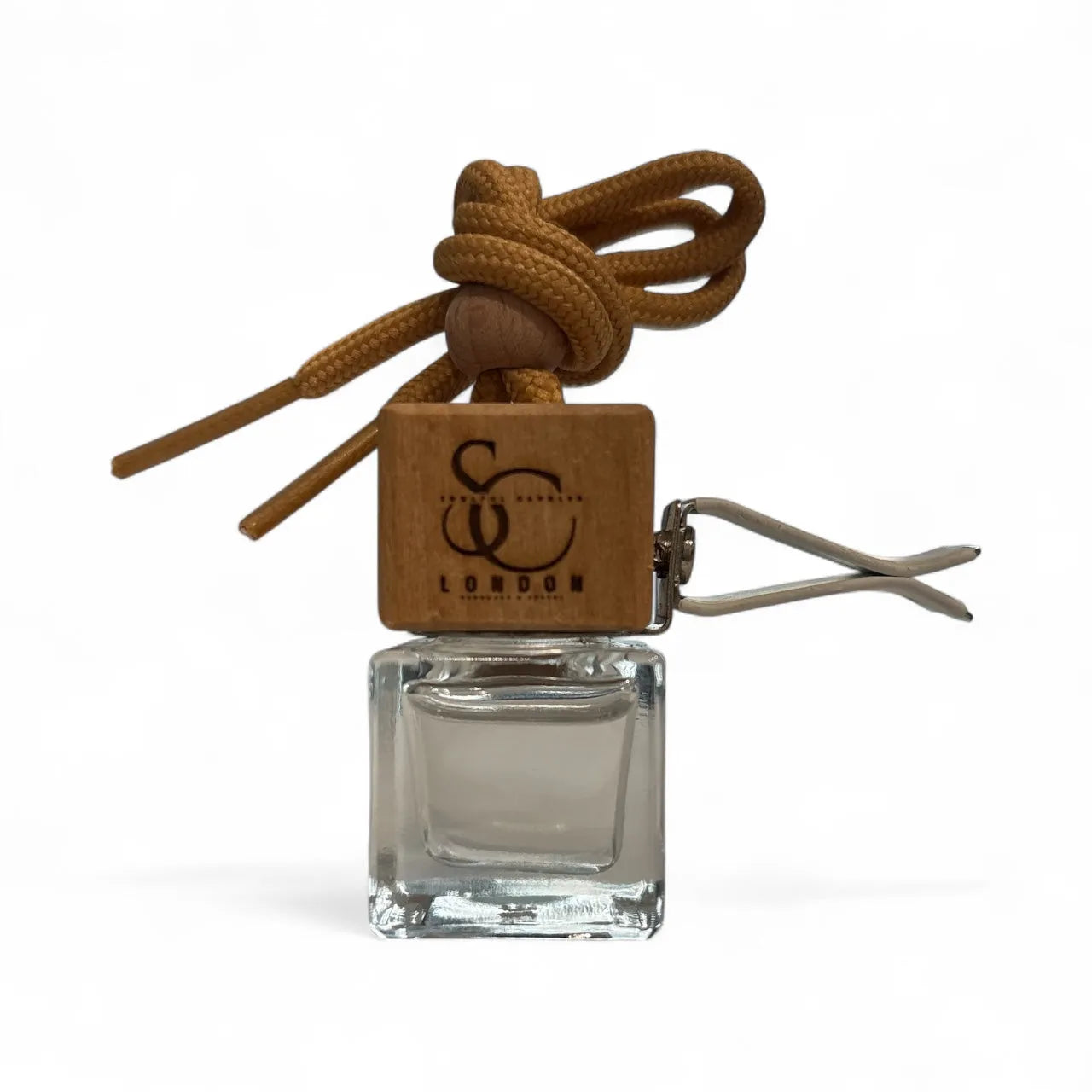 Clear glass car air freshener with brown rope and wooden tag on a white background