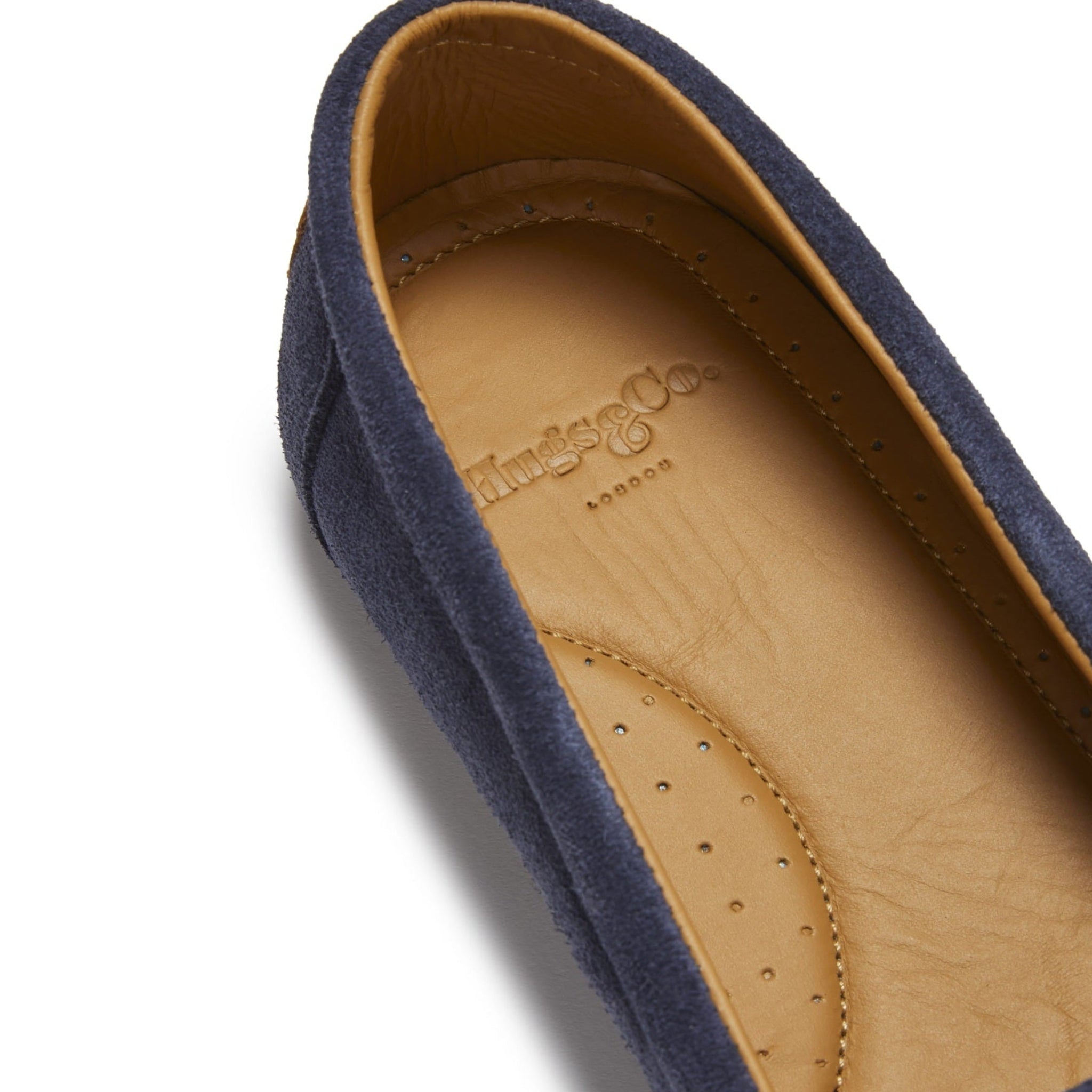 Navy blue shoe with tan insole on a white background
