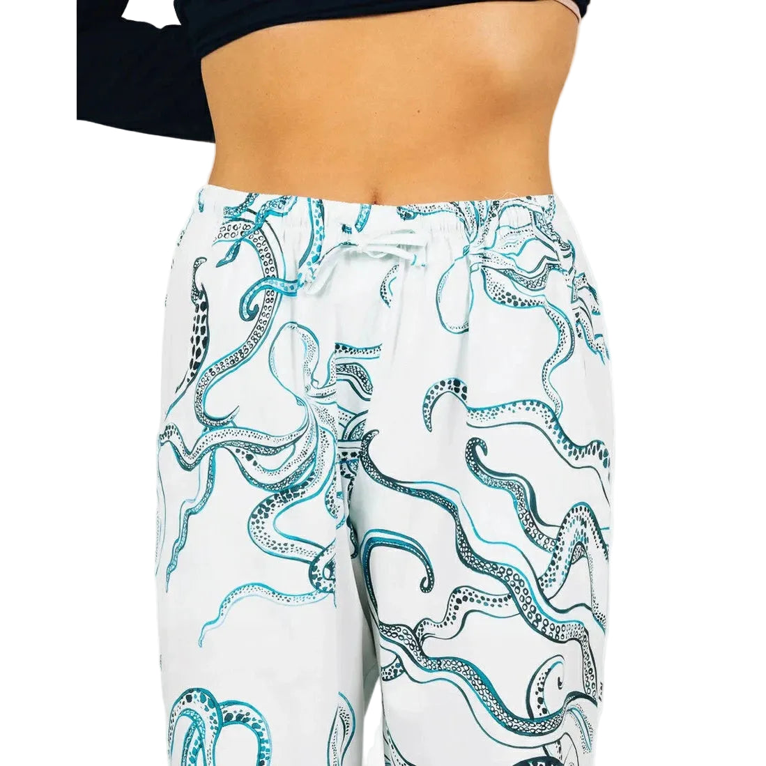 White pants with blue octopus pattern worn by a person on a white background
