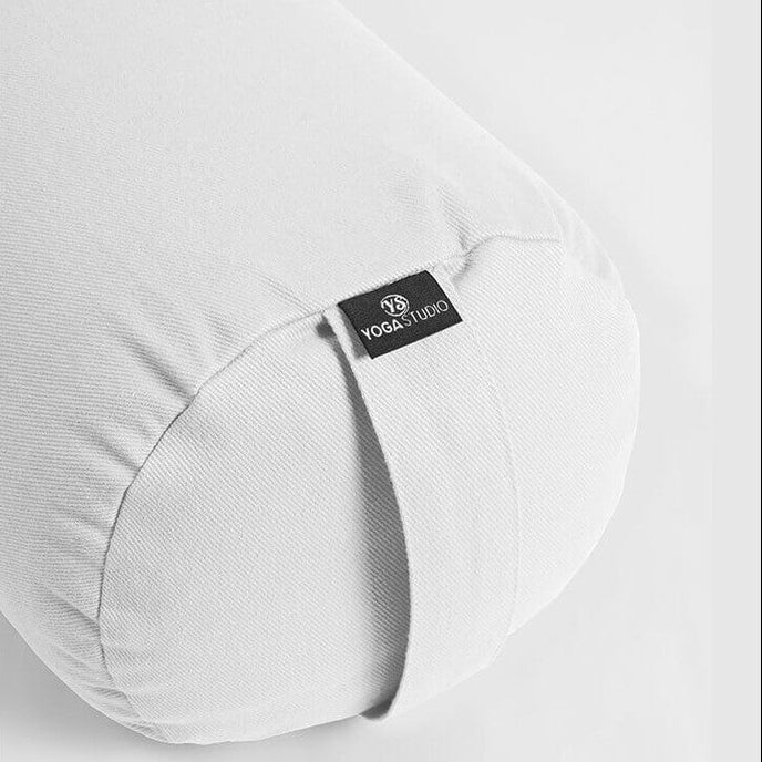 Grey yoga bolster with a visible brand label on a light grey background