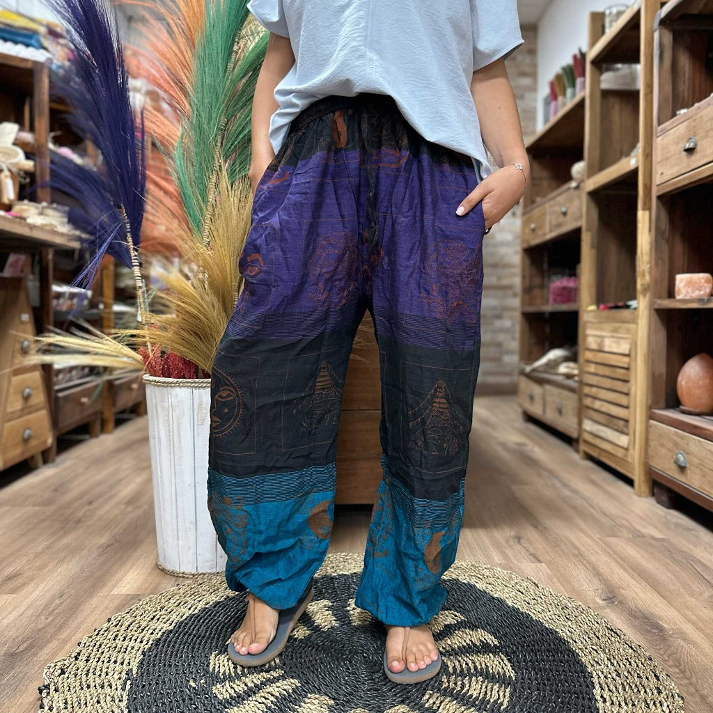 Cotton Yoga Trousers Comfy Festival Pants - Colourful Himalayan prints.a full range of Yoga and Festival Pants for you, all made from 100% cotton. These pants are made in Nepal and are super soft, lightweight, and stylish. They come in one size that fits everyone, making them a great choice for most people. Plus, we deliver these yoga and festival pants in a small cotton bag to add a special touch. The collection features three styles: High Cross, Aladdin, and Fisherman