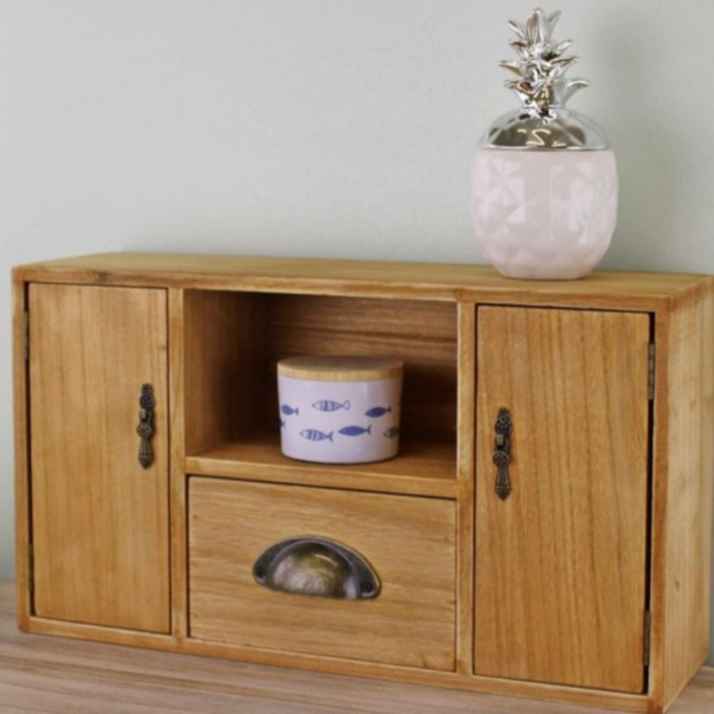 Emmy Jane Boutique Small Wooden Cabinet with Cupboards, Drawer and Shelf.Classic Trinket Drawers . This small wooden cabinet would be perfect for a desk or dressing table, with 2 cupboards featuring fancy handles and magnetic closing latches, 1 drawer with a metal handle, and 1 shelf area. The drawer is interchangeable between both middle spaces.