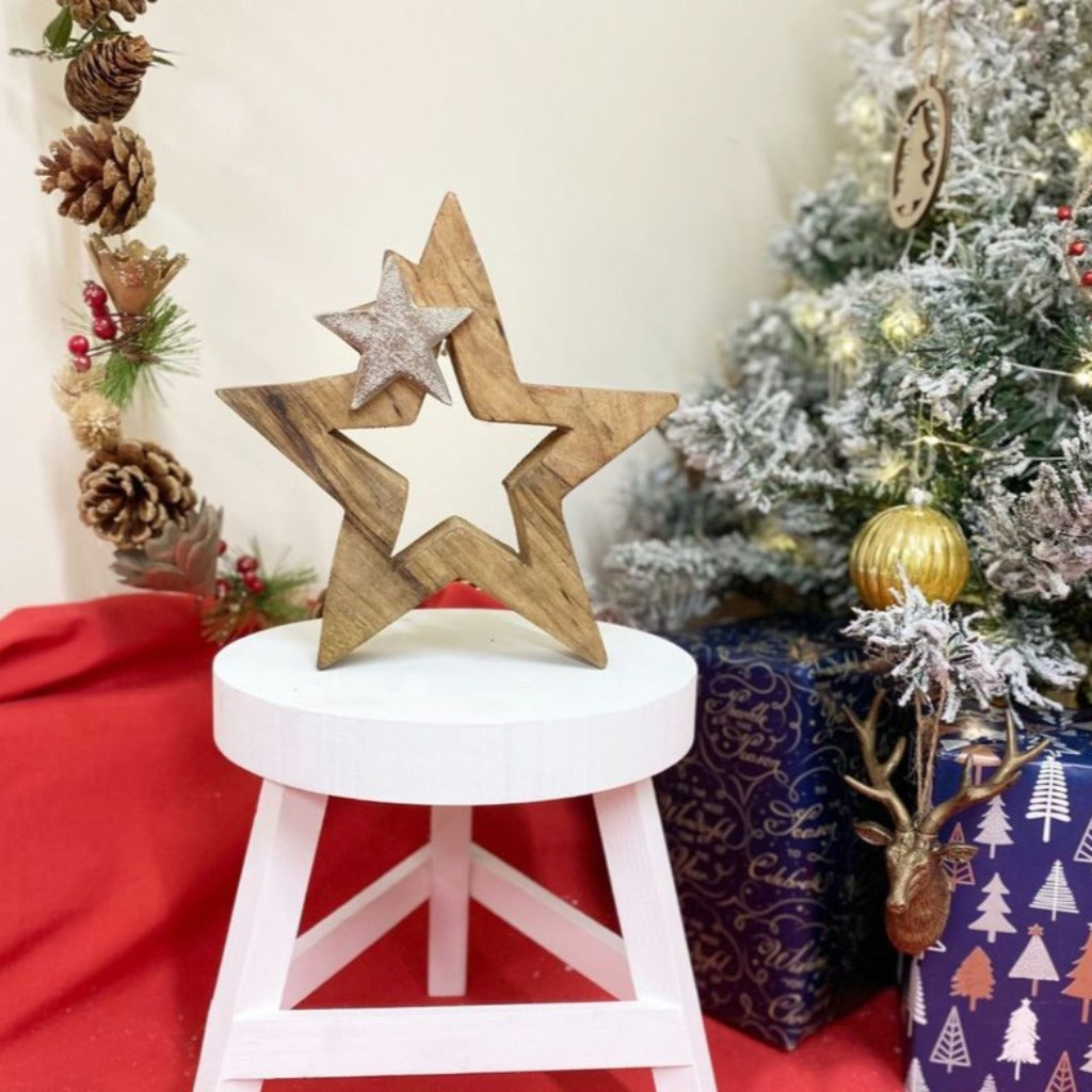 Emmy Jane Boutique Wood & Silver Metal Star Decoration 20cm. A chunky solid wooden star shape with a smaller silver star shape at the top. A free-standing block is a simple design to complement the Christmas decorations in your home.