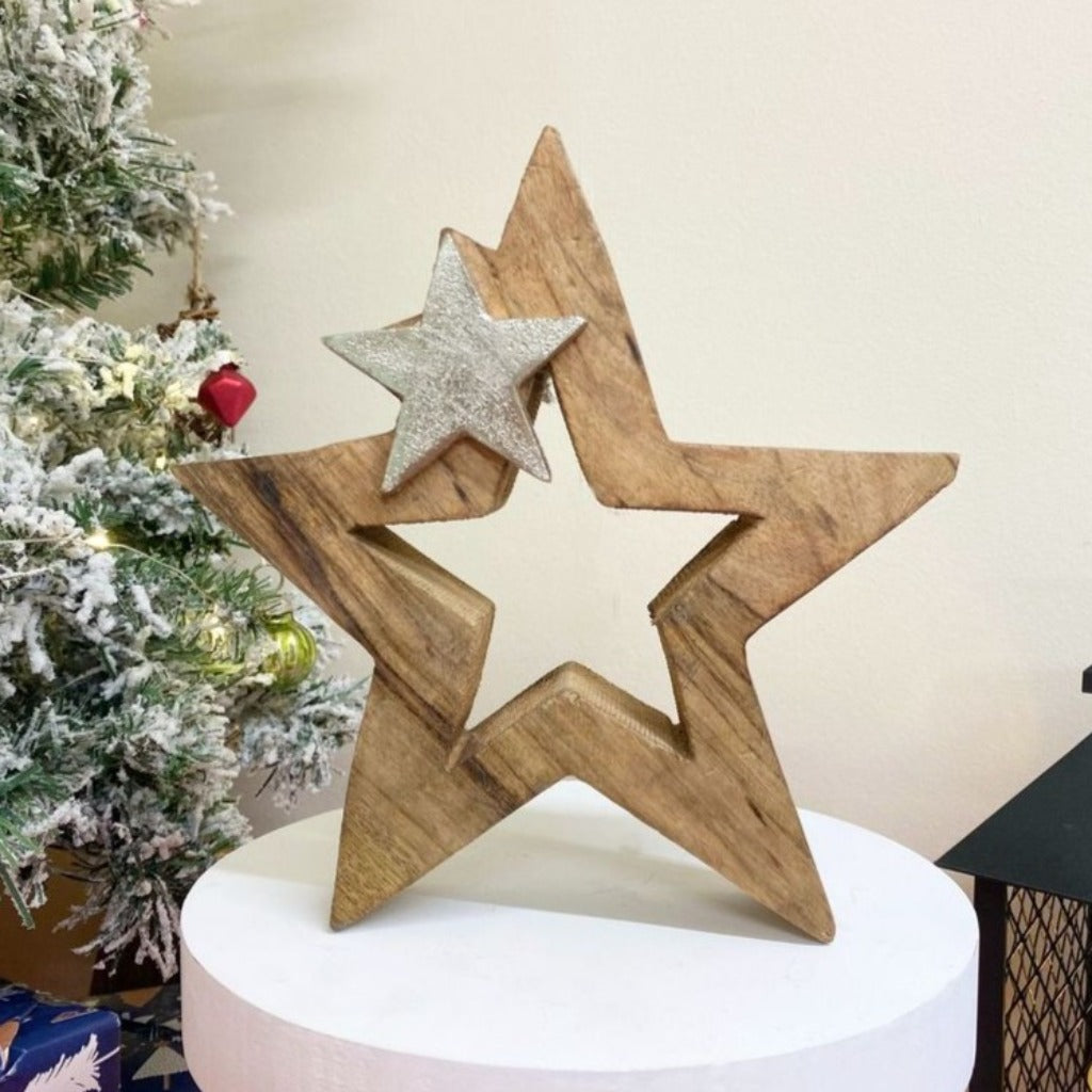Emmy Jane Boutique Wood & Silver Metal Star Decoration 20cm. A chunky solid wooden star shape with a smaller silver star shape at the top. A free-standing block is a simple design to complement the Christmas decorations in your home.