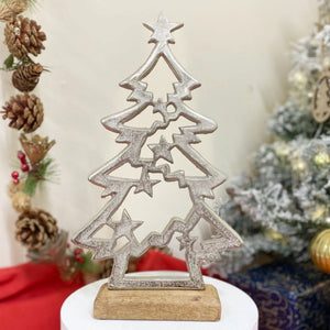 Emmy Jane Boutique - Christmas Decor Silver - Metal Christmas Tree & Stars On Wooden Base. A contemporary design of a silver Christmas tree shape, fixed upon a wooden plinth. A striking decoration to enhance your Christmas displays. Silver Christmas tree Material wood and metal Colour Silver Measurements: Depth 4.8 cm x Height 31 x Width 18cm Weight 1 kg.
