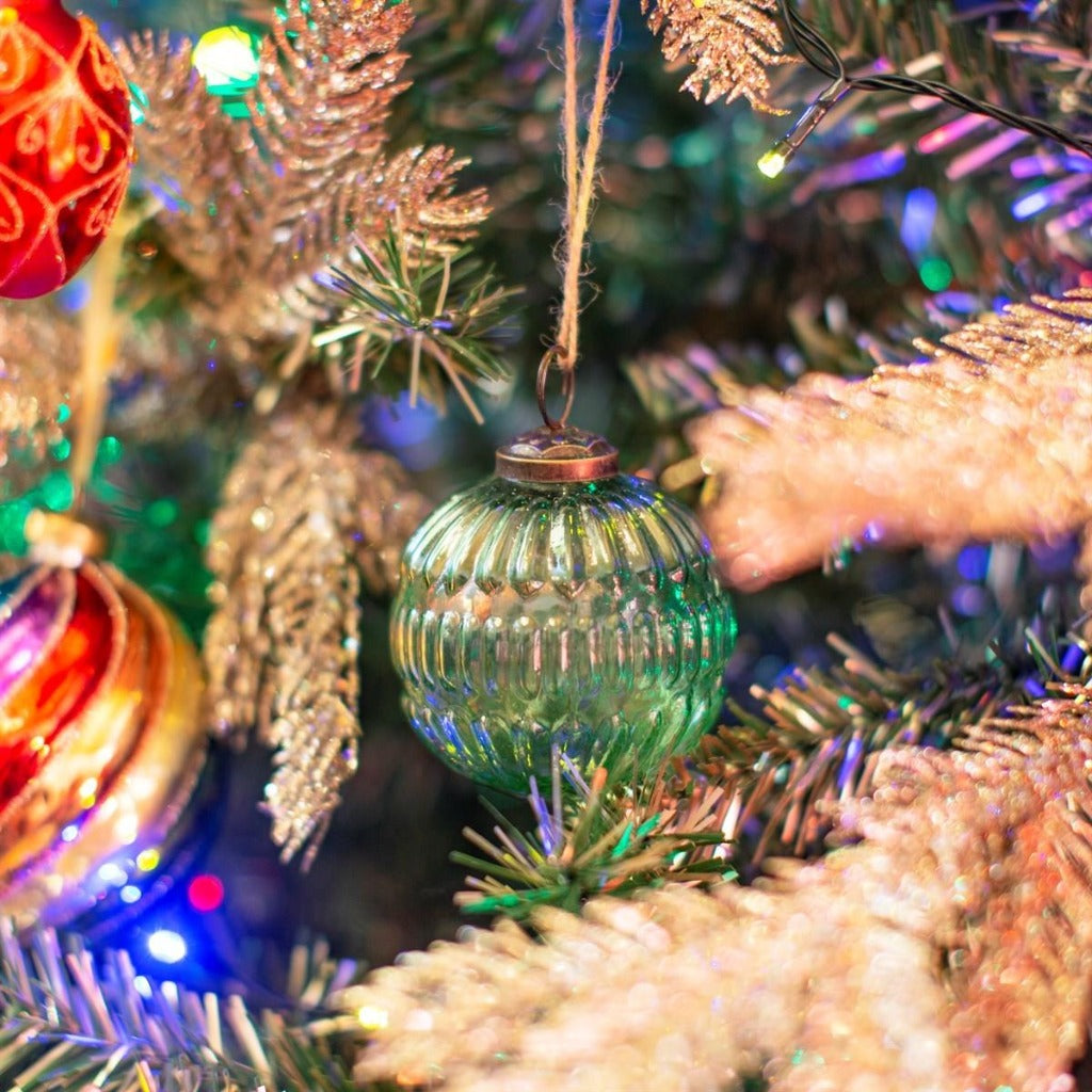 Emmy Jane Boutique -Eco-Friendly Christmas Tree Decoations - Green Recycled Glass Baubles. This green-coloured glass, grooved bauble is designed with the future in mind and the earth at heart. Go back to basics with the minimalistic design and recycled glass material. A true embrace of the real green in the festive season.