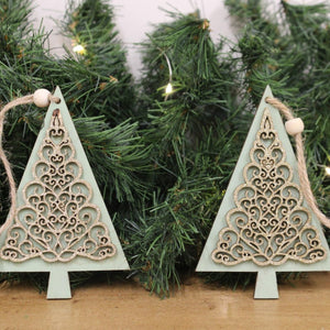 Emmy Jane Boutique - Wooden Christmas Tree Decorations - Pair of Hanging Tree Decorations.A charming pair of wooden hanging tree decorations, in shades of green. Both decorations feature gold tree print decals, complete with a jute hanger.