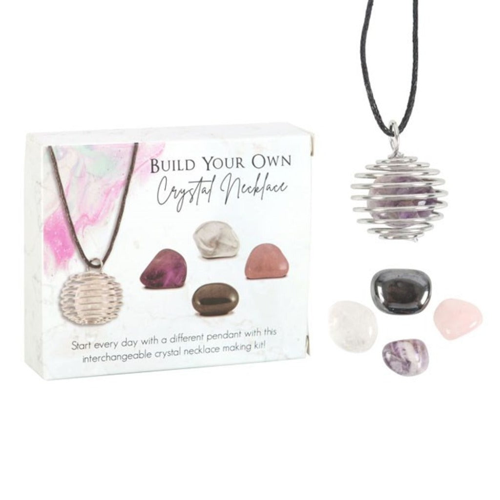 'Build your own' crystal necklace kit. Includes 4 tumble stones and a nickel-free spiral cage necklace for easily swapping out the stones. Crystals include amethyst rose quartz, clear quartz, and hematite presented in a matching gift box. 