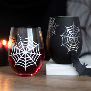 Halloween Glasses Set of 2 - Spider Web Stemless Wine Glasses - Black. This set of 2 stemless glasses is perfect for nights of mischief. Designs feature a printed spider and his web (clear glass) and an eye-catching web silhouette with a silver interior (black). Perfect for your Halloween Dinner Party