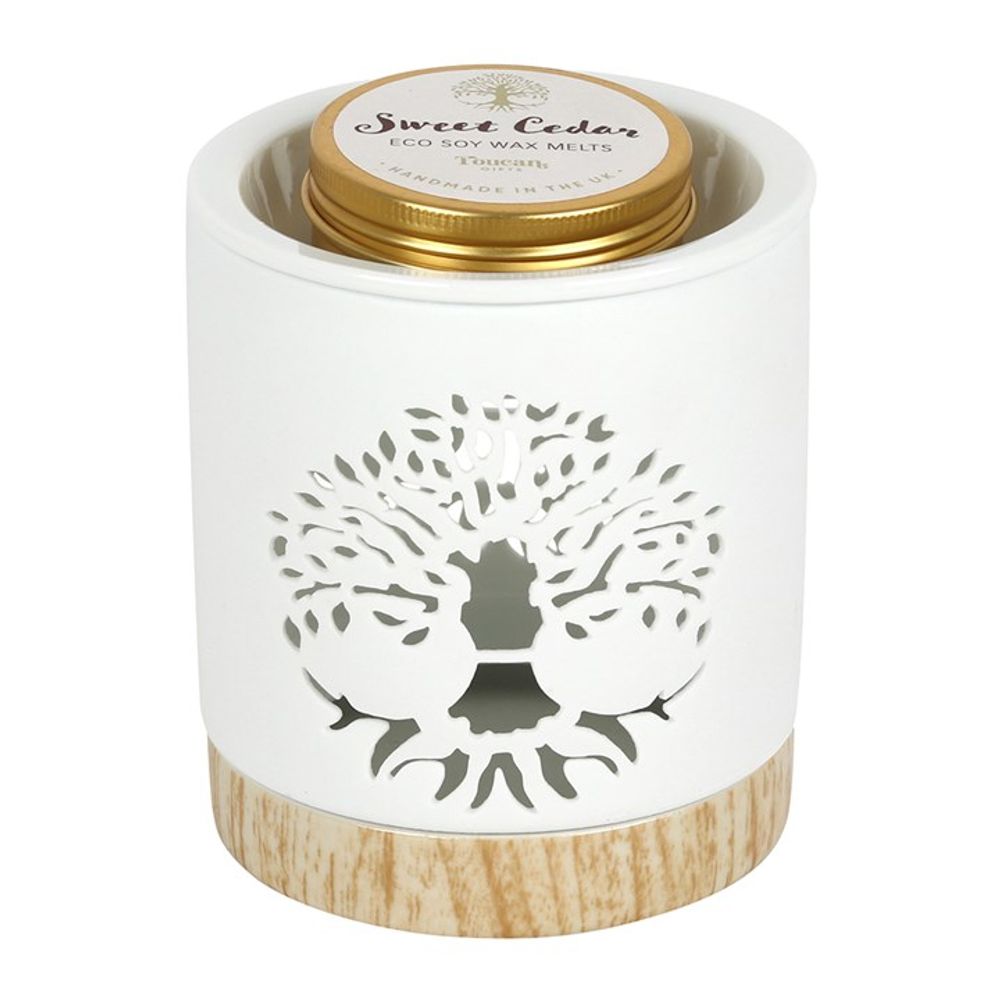 Wax Melts Gift Set - Soy Wax Sweet Cedar - Tree of Life Wax Warmer Gift Set. Fragrance the home with this elegant Tree of Life wax warmer gift set. A white ceramic burner is accented by a wood-effect base and a stunning Tree of Life cut-out design. The set includes a tin of eco soy wax melts in the scent 'Sweet Cedar' that exudes the feeling of forest walks and cabin getaways.