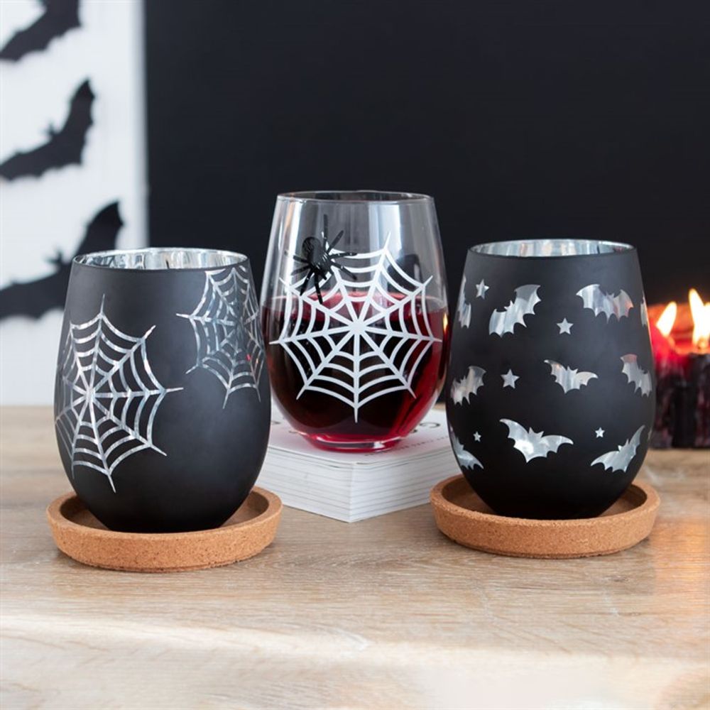 Halloween Glasses Set of 2 - Spider Web Stemless Wine Glasses - Black. This set of 2 stemless glasses is perfect for nights of mischief. Designs feature a printed spider and his web (clear glass) and an eye-catching web silhouette with a silver interior (black). Perfect for your Halloween Dinner Party